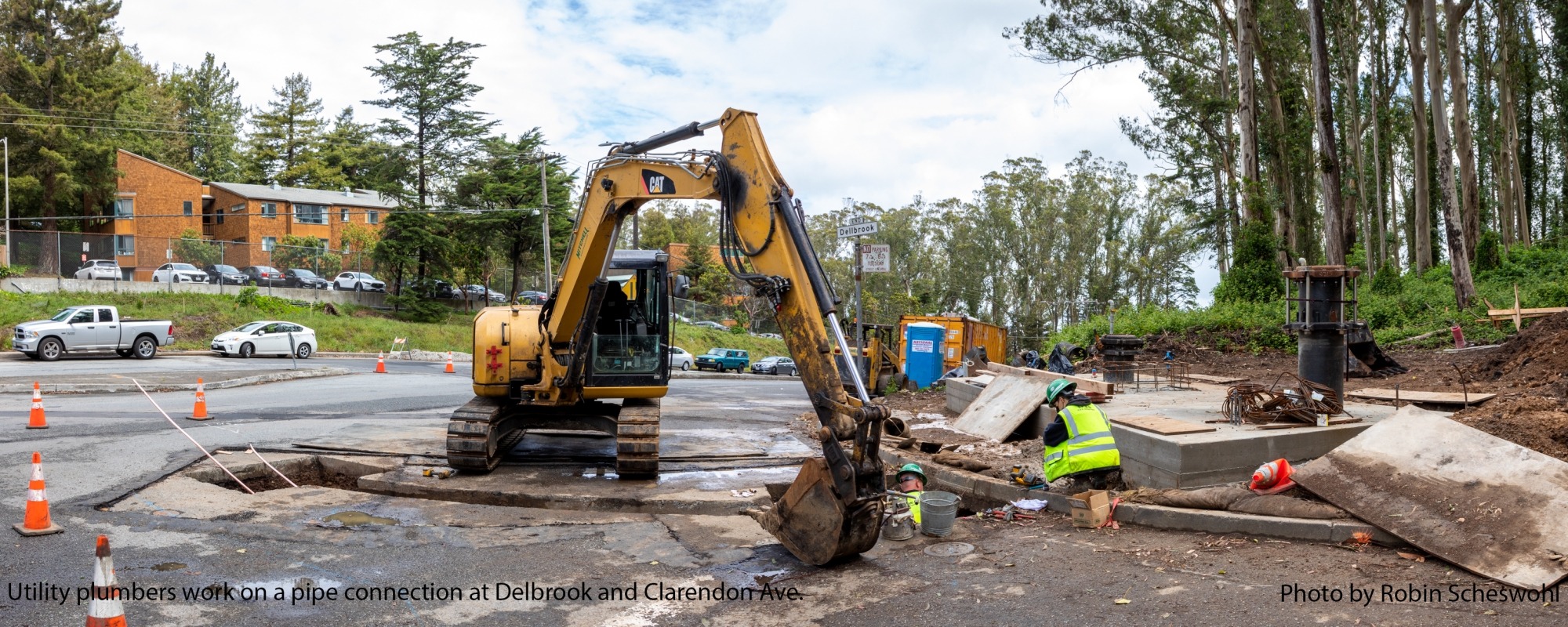 Utility plumbers work on a pipe connection at Delbrook and Clarendon Ave.