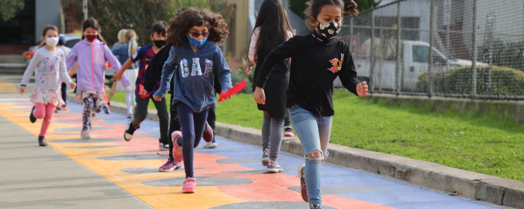 Kids play on the new Hop Skip & Play Sidewalk Installation